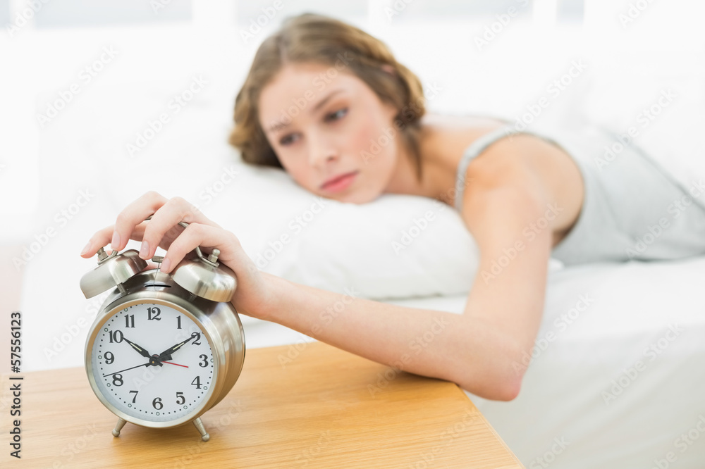 Beautiful woman waking up while lying in her bed Beautiful woman waking up while lying in her bed