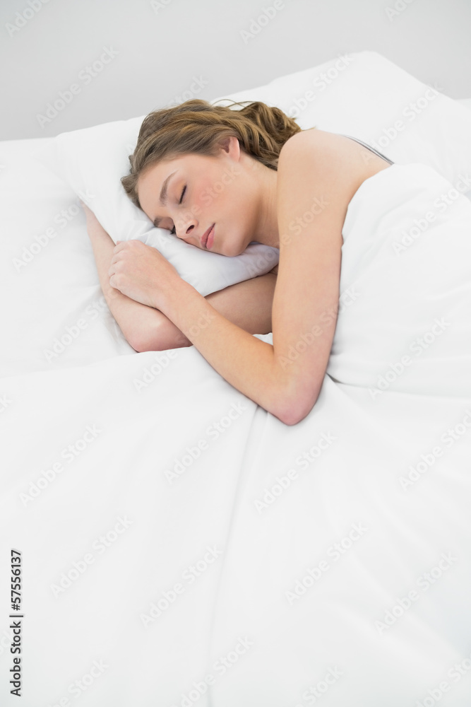 Lovely sleeping woman lying under the cover on her white bed Lovely sleeping woman lying under the cover on her white bed