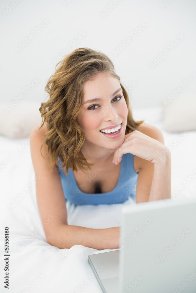 Lovely smiling woman using her notebook looking at camera Lovely smiling woman using her notebook looking at camera