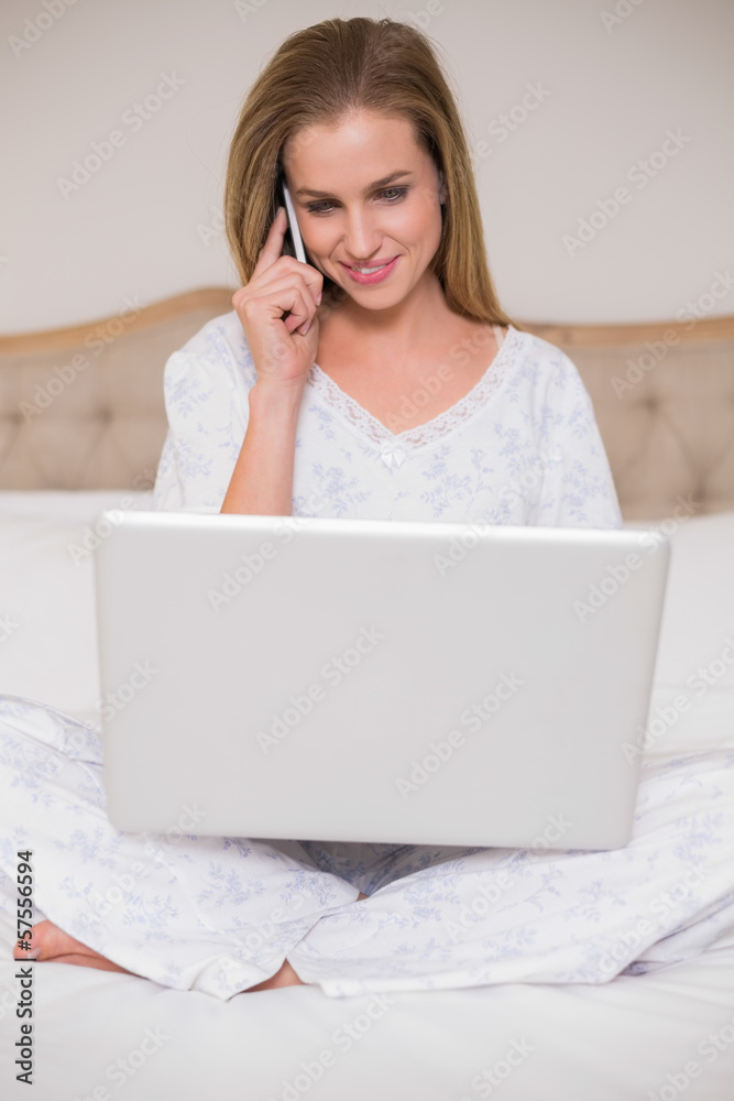 Natural content woman using laptop and phoning Natural content woman using laptop and phoning