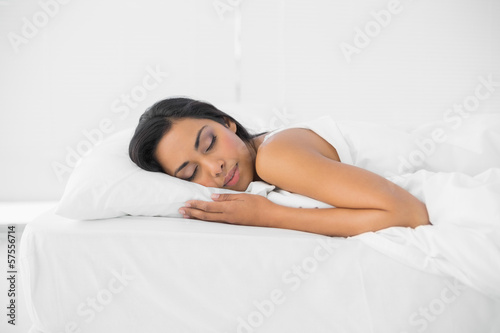 Calm sleeping woman lying on her bed
