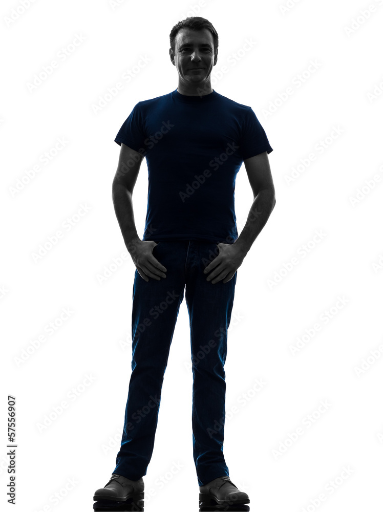 man standing smiling with thumbs in pockets silhouette
