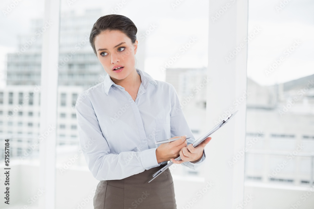 Elegant businesswoman with graphs in office Elegant businesswoman with graphs in office