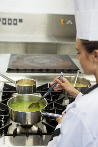 Young chef stirring sauce