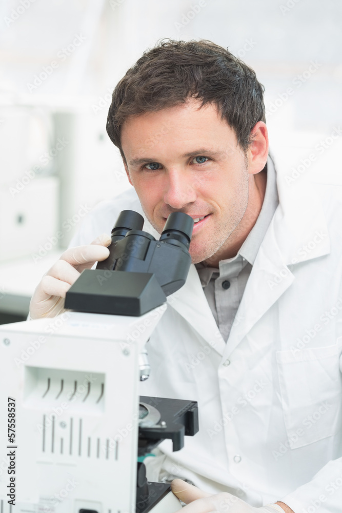 Scientific researcher using microscope in the laboratory Scientific researcher using microscope in the laboratory