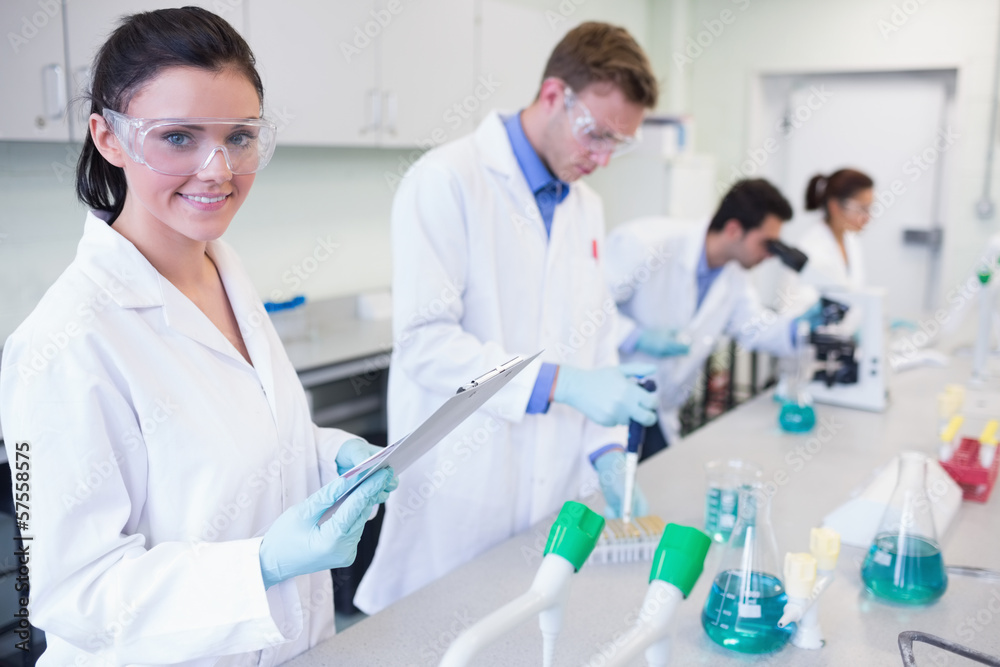 Researchers carrying out experiments in the lab Researchers carrying out experiments in the lab