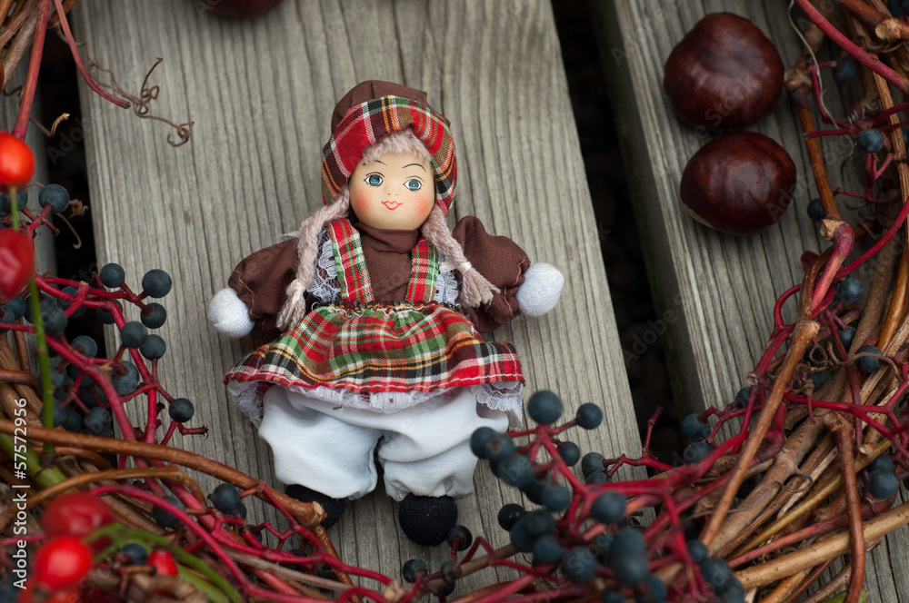 Toy doll with autumn decoration