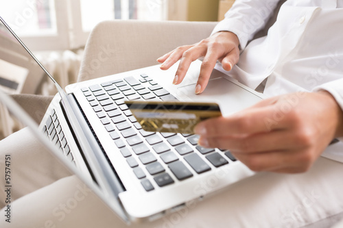 Woman s holding a credit card and using laptop  online shopping