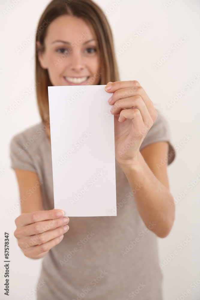 Cheerful girl on white background holding leaflet for message Cheerful girl on white background holding leaflet for message