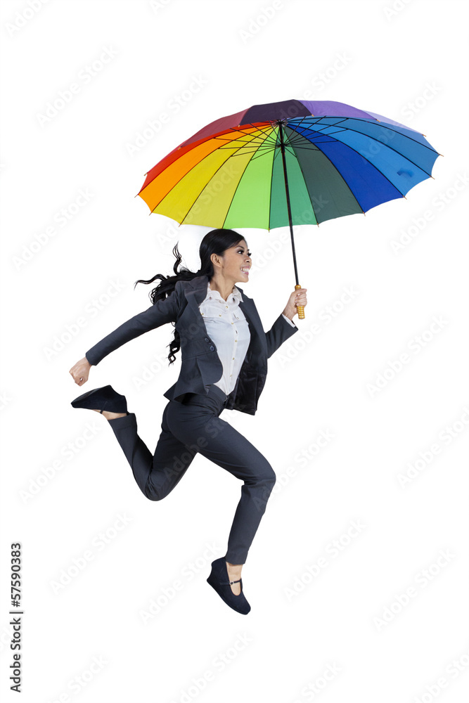 Happy businesswoman jumping with umbrella Happy businesswoman jumping with umbrella