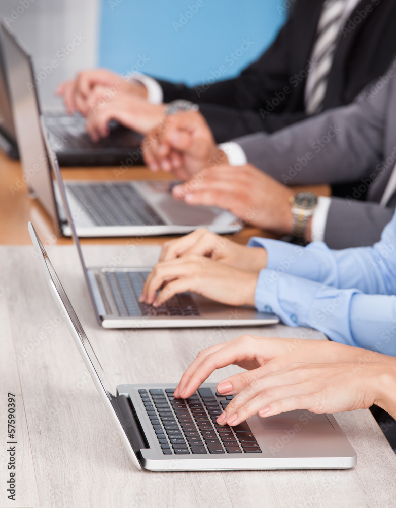 Close-up Of Businesspeople Using Laptop Close-up Of Businesspeople Using Laptop