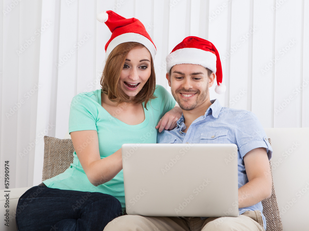 Young couple looking at laptop Young couple looking at laptop
