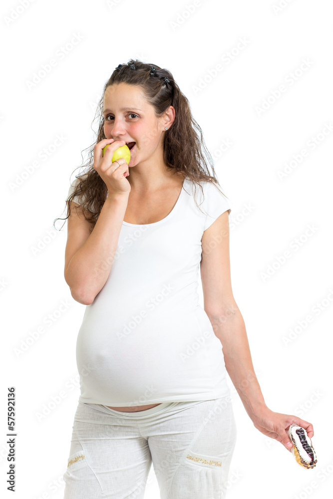 pregnant woman choosing between healthy food fruits and cake iso pregnant woman choosing between healthy food fruits and cake iso