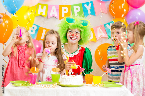 children and clown at birthday party