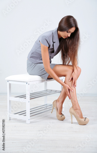Girl with sore foot isolated on white