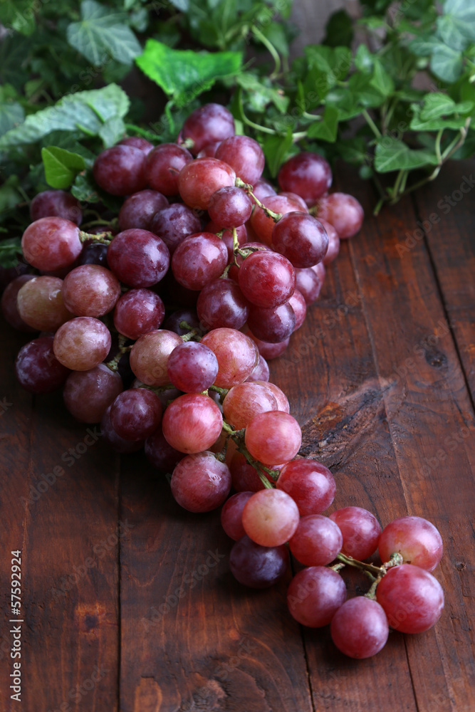 Ripe purple grapes on wooden table close-up Ripe purple grapes on wooden table close-up