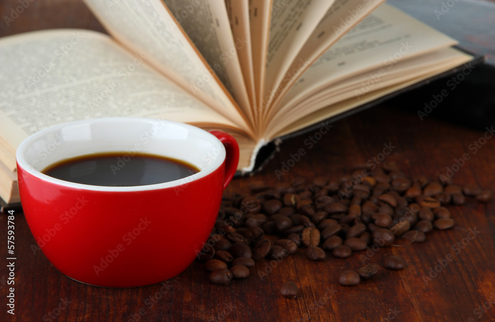Cup of coffee with coffee beans and books on wooden background Cup of coffee with coffee beans and books on wooden background