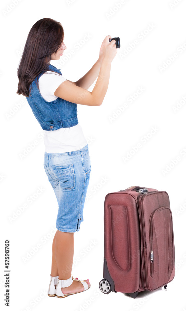 Back view of woman photographing traveling with suitcas. Back view of woman photographing traveling with suitcas.
