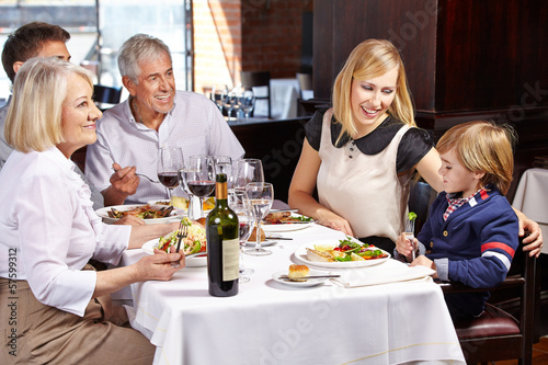 Family with child and grandparents in restaurant