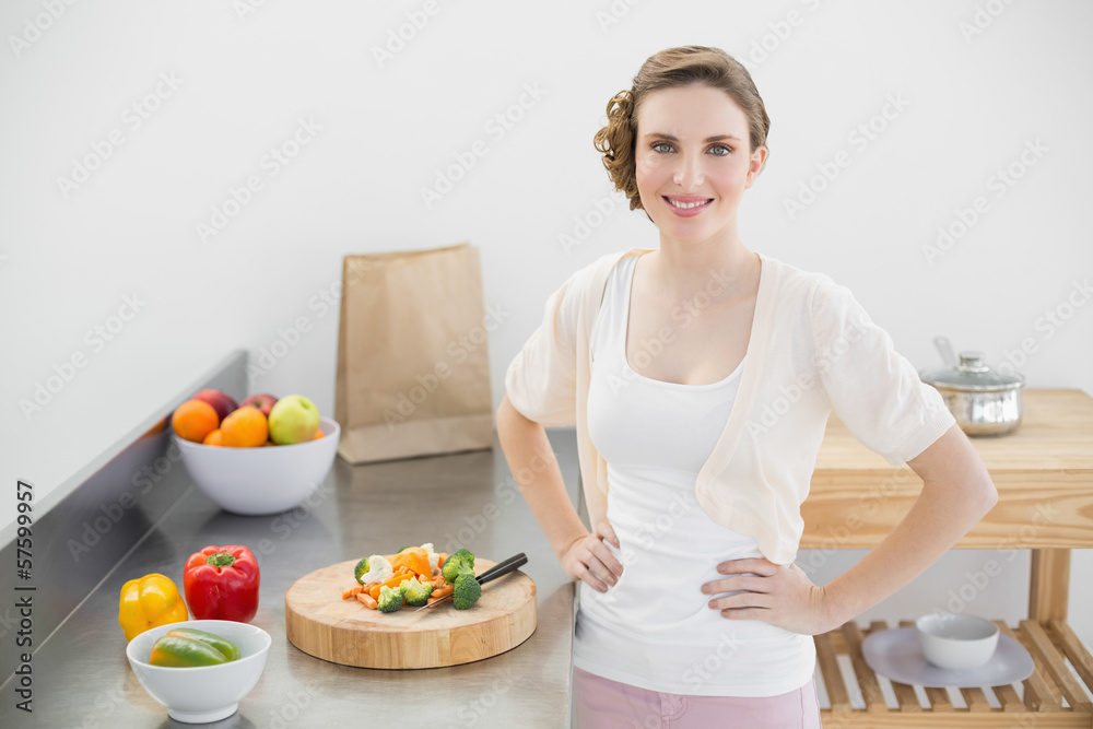 Attractive woman posing in her kitchen with hands on hips Attractive woman posing in her kitchen with hands on hips