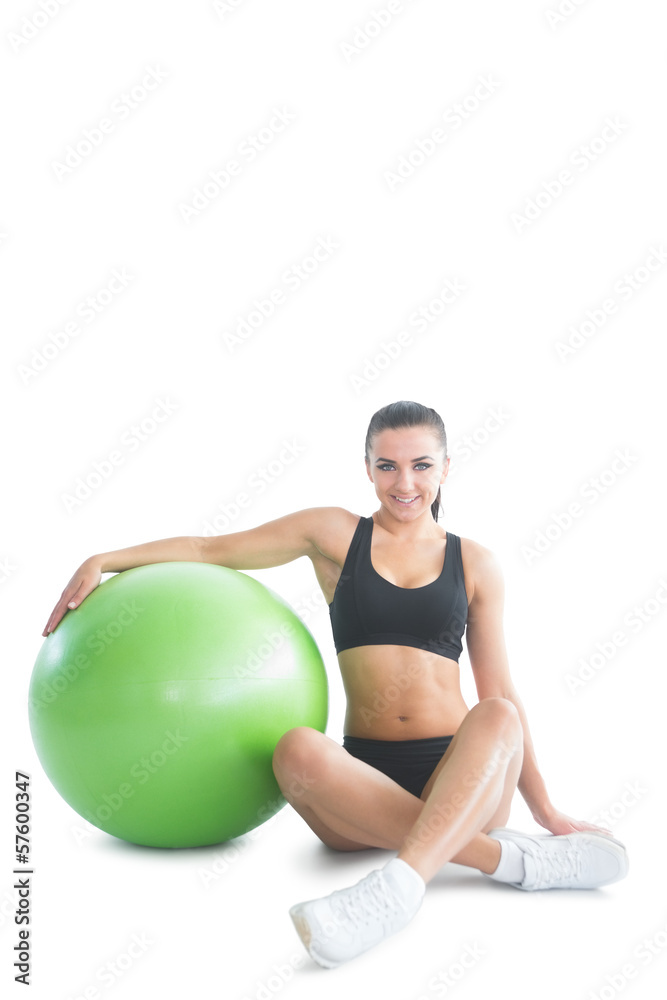Front view of attractive brunette woman posing sitting next to a Front view of attractive brunette woman posing sitting next to a