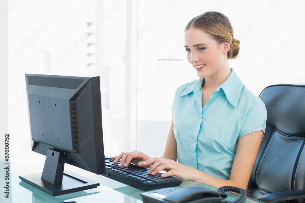 Classy happy businesswoman working at computer