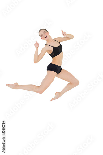 Cheerful slim model jumping in the air