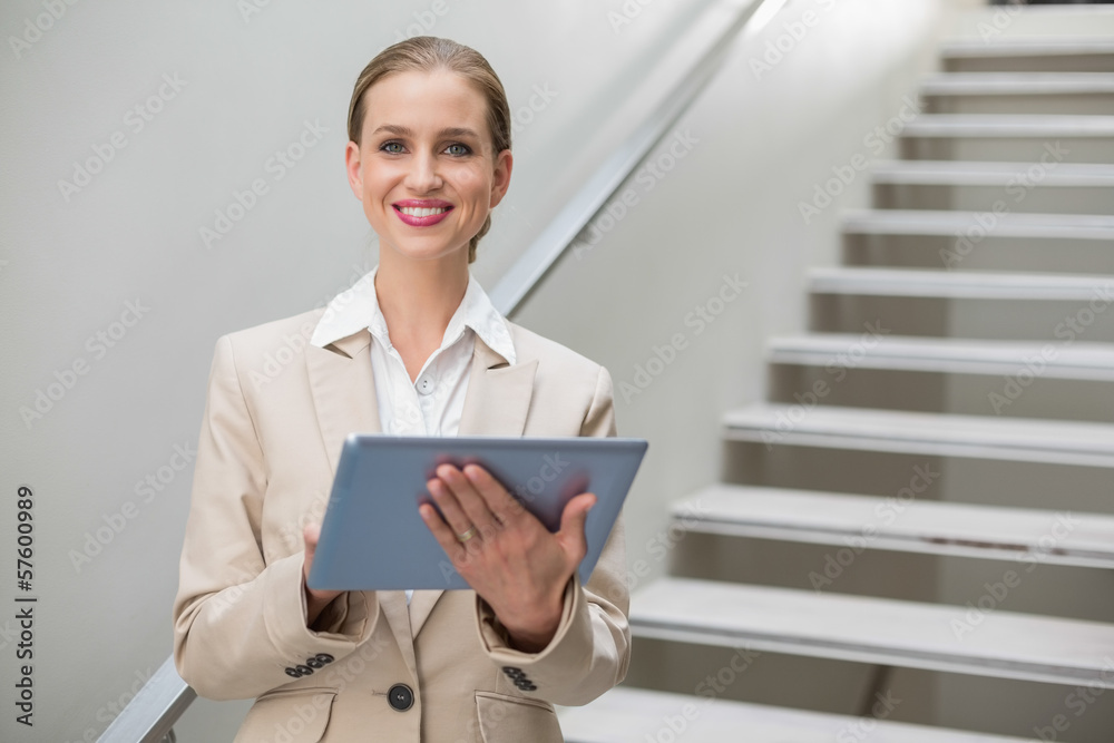 Cheerful stylish businesswoman holding tablet Cheerful stylish businesswoman holding tablet