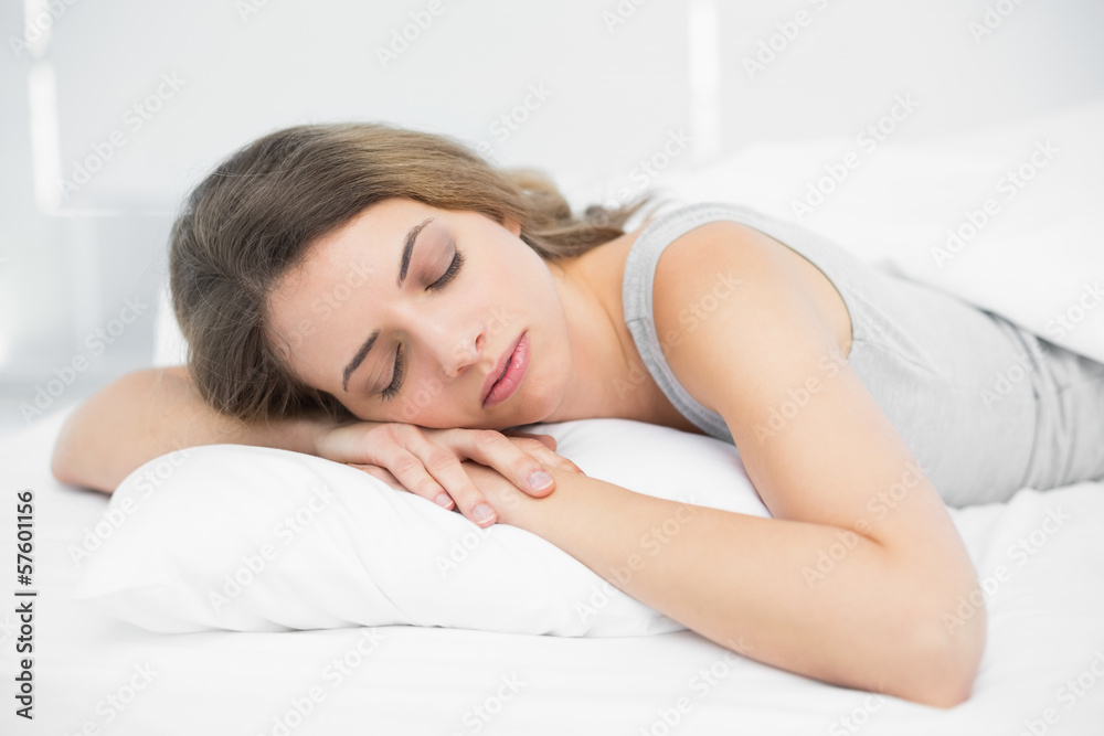 Lovely brunette woman napping lying on her bed Lovely brunette woman napping lying on her bed