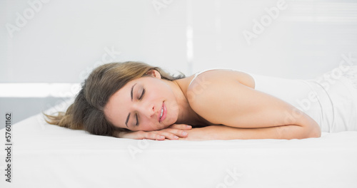 Cute brunette woman sleeping lying on her bed