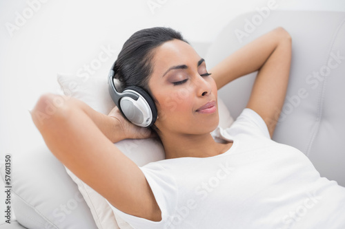 Cute relaxing woman listening to music