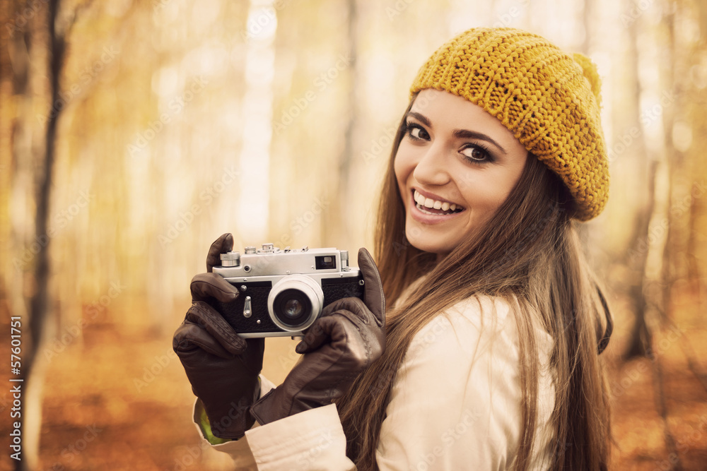 Smiling young woman holding retro camera Smiling young woman holding retro camera
