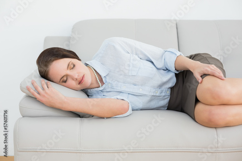 Beautiful well dressed woman sleeping on sofa