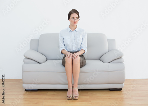 Free Download Full length of a serious well dressed woman on sofa - GFXLoad