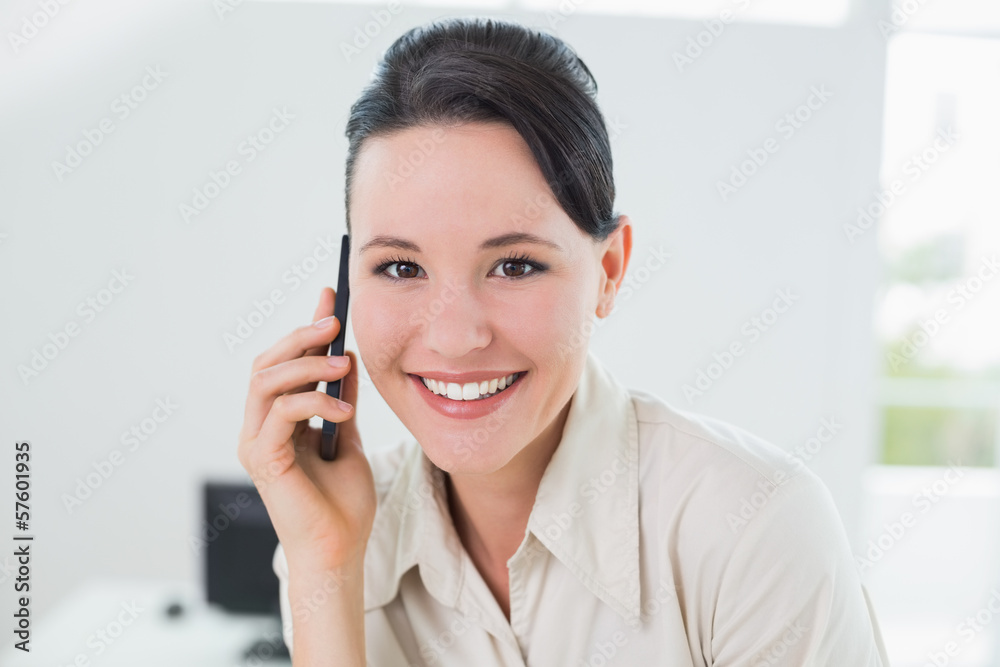 Smiling businesswoman using cellphone in office Smiling businesswoman using cellphone in office