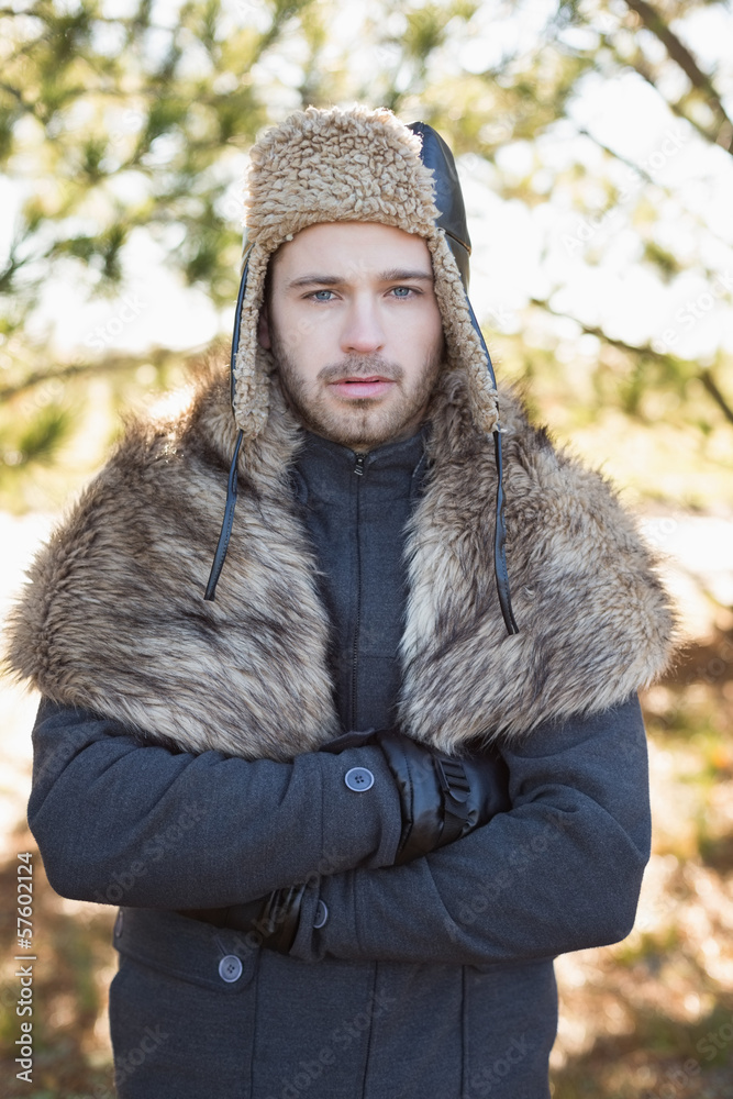 Handsome man in warm clothing standing in forest Handsome man in warm clothing standing in forest