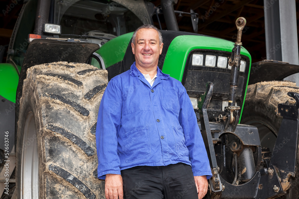 Farmer standing in front of his tractor