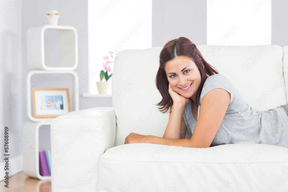 Cheerful young woman relaxing on a couch
