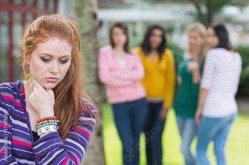 Student being bullied by a group of students photo