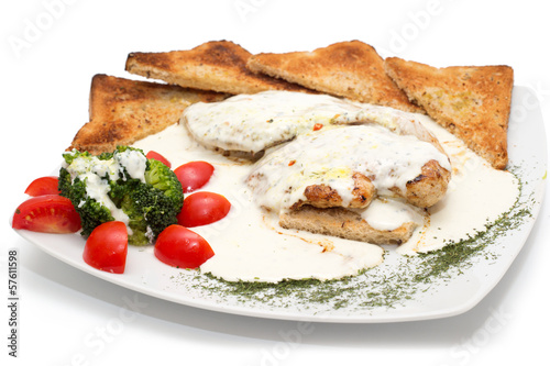 Chicken with gorgonzola  vegetables and bread on the plate