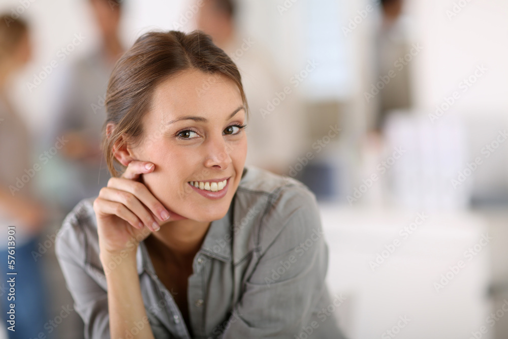 Portrait of business girl sitting on table in office Portrait of business girl sitting on table in office