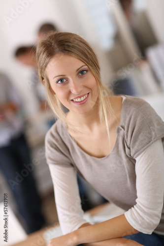 Young woman in office, people in background Free Download Young woman in office, people in background - GFXLoad