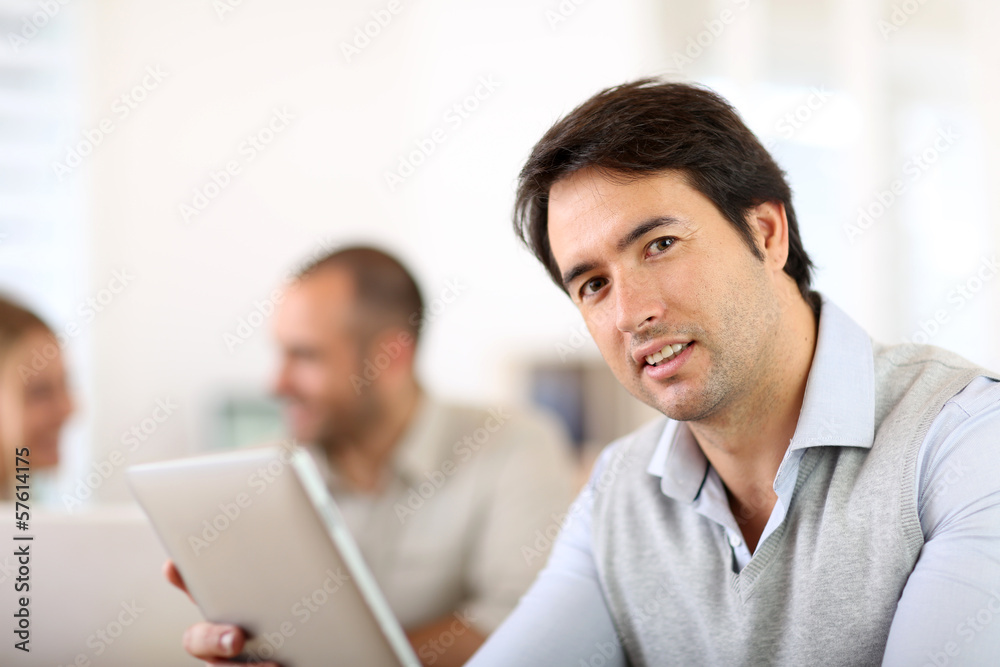 Businessman in office working on digital tablet