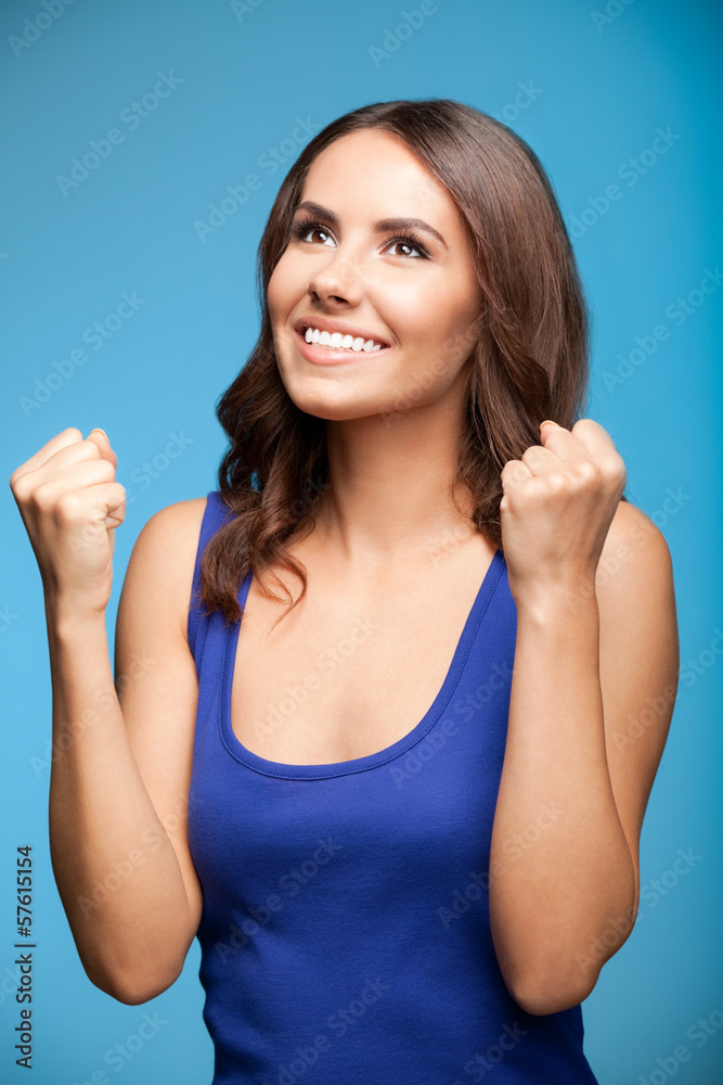 Happy gesturing young woman, over blue Happy gesturing young woman, over blue