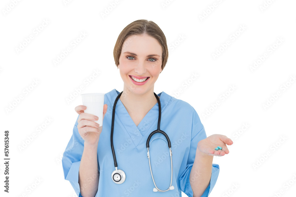Female doctor holding a plastic cup and blue pills Female doctor holding a plastic cup and blue pills