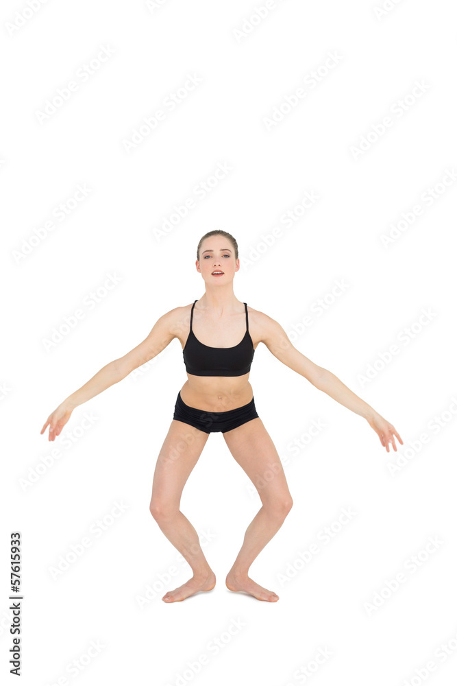 Focused slim ballet dancer jumping in the air Focused slim ballet dancer jumping in the air