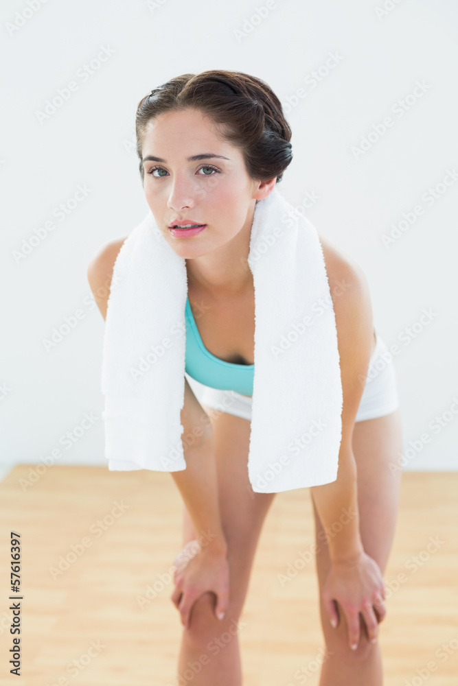 Fired woman with towel around neck at fitness studio Fired woman with towel around neck at fitness studio