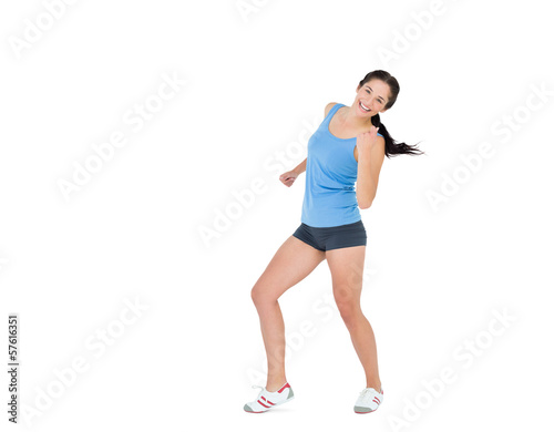 Active woman dancing over white background