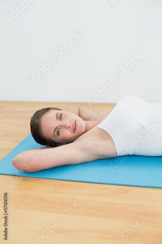 Young woman resting on exercise mat