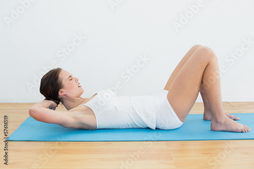 Side view of woman exercise on mat